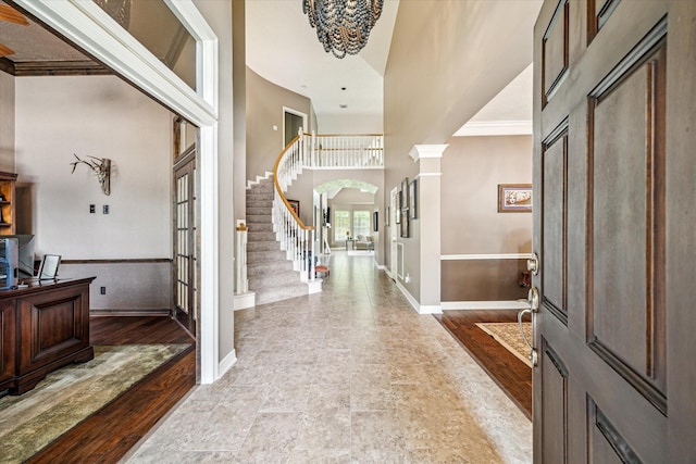 2334 River Rock Trl, Kingwood, TX 77345 - foyer with a high ceiling, stairway, arched walkways, french doors, and crown molding