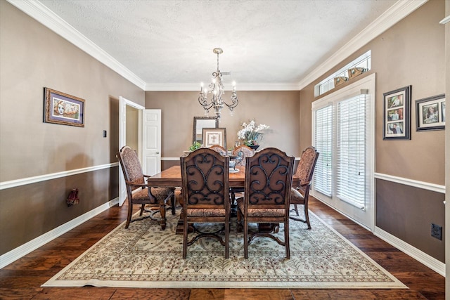 2334 River Rock Trl, Kingwood, TX 77345 - dining room with a chandelier, dark wood finished floors, and ornamental molding