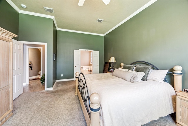 2334 River Rock Trl, Kingwood, TX 77345 - carpeted bedroom featuring ornamental molding, ensuite bathroom, and ceiling fan