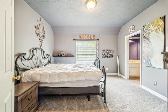 2334 River Rock Trl, Kingwood, TX 77345 - carpeted bedroom with a textured ceiling and connected bathroom