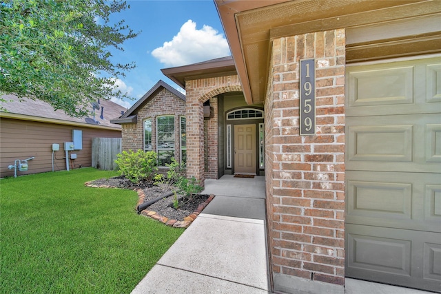 1959 Briar Grove Dr, Conroe, TX 77301 - property entrance featuring brick siding, a yard, and an attached garage