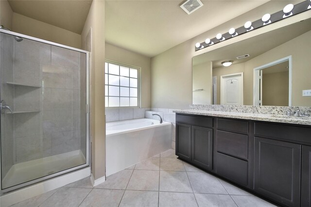1959 Briar Grove Dr, Conroe, TX 77301 - full bathroom featuring double vanity, a stall shower, a bath, and tile patterned floors