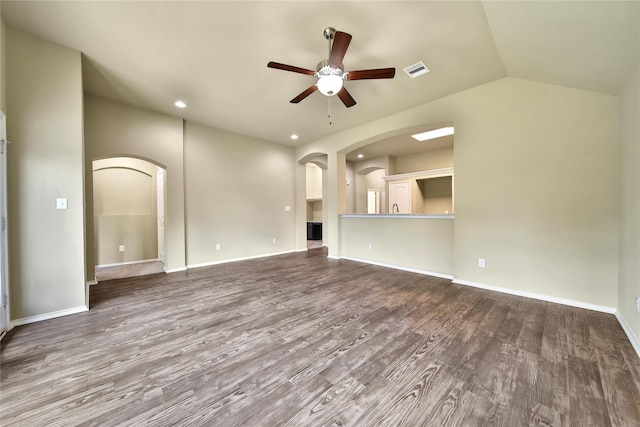 1959 Briar Grove Dr, Conroe, TX 77301 - unfurnished living room featuring arched walkways, a ceiling fan, wood finished floors, vaulted ceiling, and recessed lighting