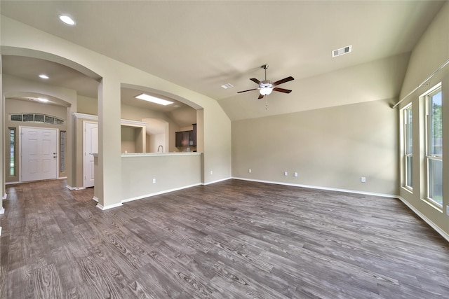 1959 Briar Grove Dr, Conroe, TX 77301 - unfurnished living room featuring ceiling fan, dark wood-style floors, vaulted ceiling, recessed lighting, and arched walkways