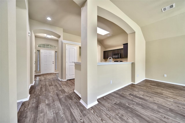 1959 Briar Grove Dr, Conroe, TX 77301 - interior space featuring dark wood-style flooring, arched walkways, lofted ceiling, and recessed lighting