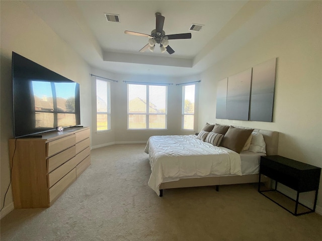 20718 Slate Ct, Richmond, TX 77407 - bedroom with light carpet, a tray ceiling, and ceiling fan