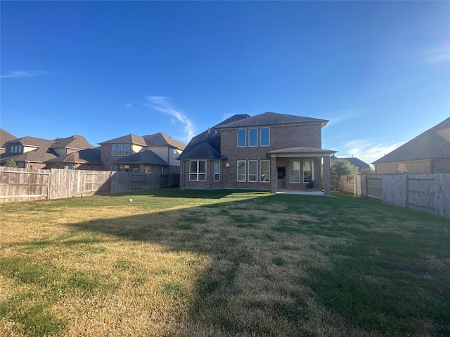 20718 Slate Ct, Richmond, TX 77407 - back of house featuring a fenced backyard, brick siding, and a residential view