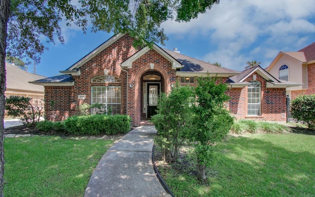 16214 Lobo Ln, Spring, TX 77379 - view of front of property featuring brick siding and a front lawn