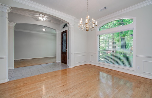 16214 Lobo Ln, Spring, TX 77379 - empty room with decorative columns, wood finished floors, ornamental molding, a ceiling fan, and arched walkways