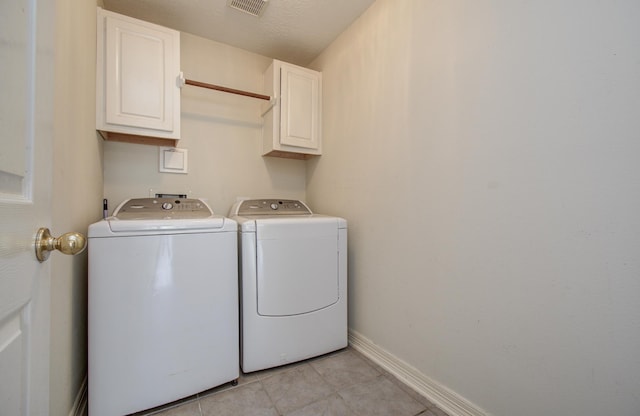 16214 Lobo Ln, Spring, TX 77379 - laundry area featuring cabinet space, separate washer and dryer, and light tile patterned flooring