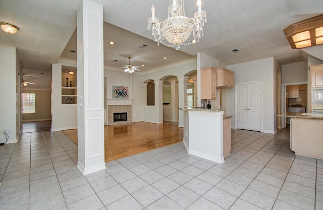 16214 Lobo Ln, Spring, TX 77379 - kitchen with ornamental molding, a ceiling fan, light tile patterned flooring, a fireplace, and recessed lighting