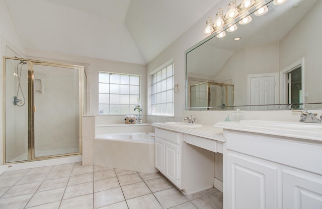 16214 Lobo Ln, Spring, TX 77379 - full bathroom with vaulted ceiling, double vanity, a bath, a shower stall, and tile patterned flooring