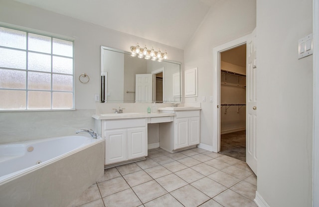16214 Lobo Ln, Spring, TX 77379 - bathroom featuring double vanity, a bath, plenty of natural light, tile patterned floors, and vaulted ceiling