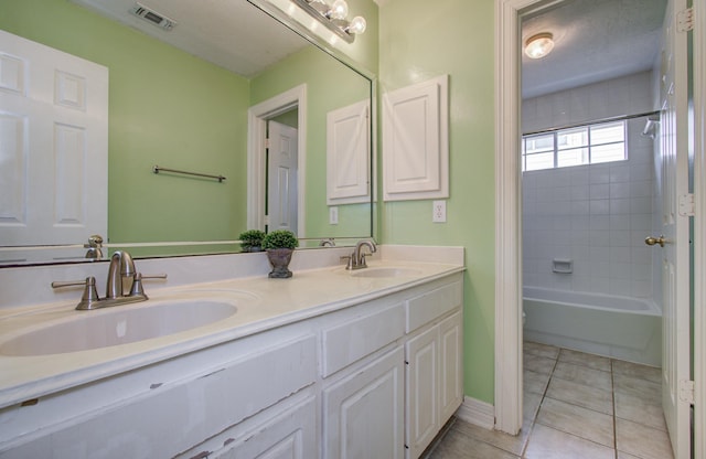 16214 Lobo Ln, Spring, TX 77379 - full bath featuring double vanity, tile patterned floors, and bathing tub / shower combination