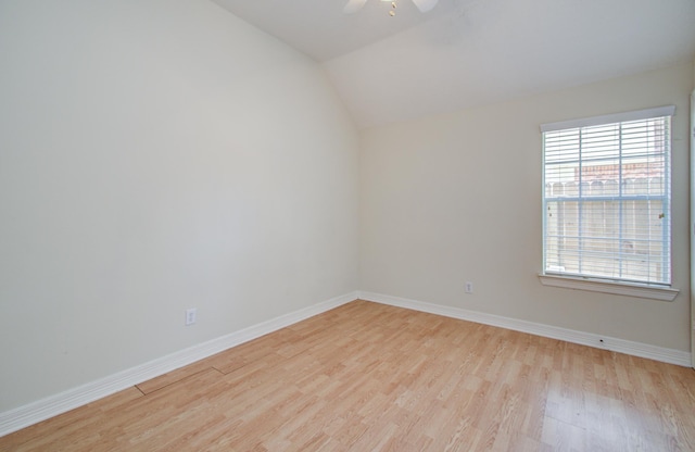 16214 Lobo Ln, Spring, TX 77379 - empty room with light wood-style floors, ceiling fan, and vaulted ceiling