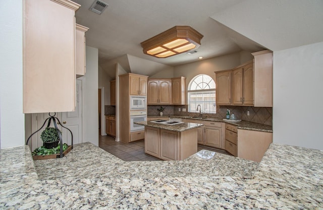 16214 Lobo Ln, Spring, TX 77379 - kitchen with white appliances, decorative backsplash, light tile patterned flooring, vaulted ceiling, and light brown cabinetry