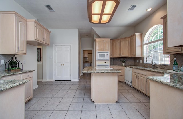 16214 Lobo Ln, Spring, TX 77379 - kitchen with white appliances, light brown cabinetry, light stone counters, decorative backsplash, and recessed lighting