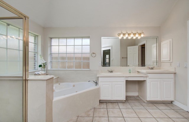 16214 Lobo Ln, Spring, TX 77379 - bathroom featuring a tub with jets, double vanity, healthy amount of natural light, and tile patterned floors