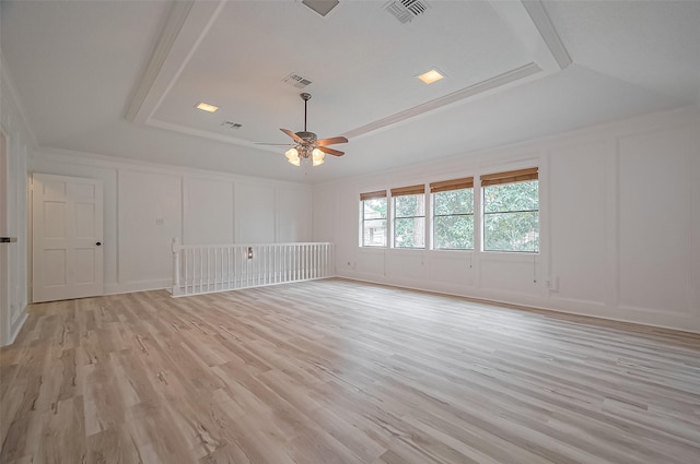 9411 Fenchurch Dr, Spring, TX 77379 - spare room featuring a decorative wall, a raised ceiling, a ceiling fan, and light wood finished floors