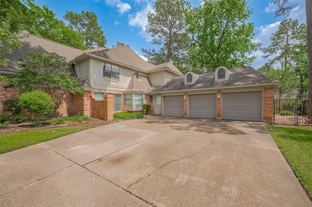 9411 Fenchurch Dr, Spring, TX 77379 - view of front of house with brick siding, concrete driveway, and a garage