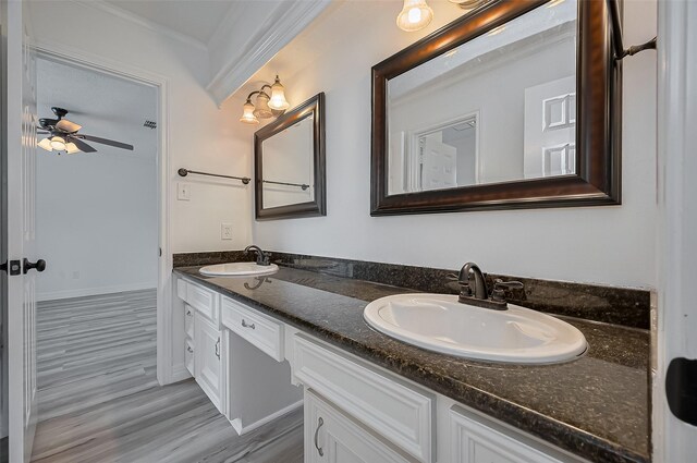 9411 Fenchurch Dr, Spring, TX 77379 - bathroom with double vanity, crown molding, ceiling fan, and wood finished floors