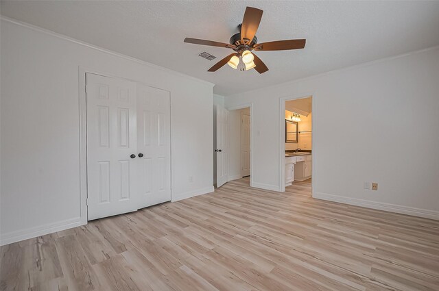 9411 Fenchurch Dr, Spring, TX 77379 - unfurnished bedroom with ornamental molding, light wood-style floors, a closet, ceiling fan, and ensuite bath