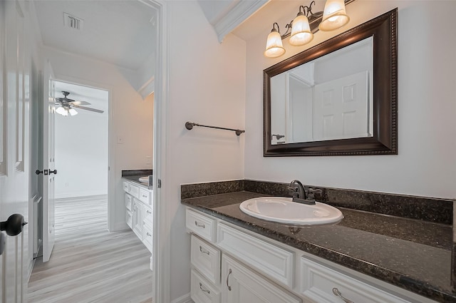 9411 Fenchurch Dr, Spring, TX 77379 - bathroom featuring vanity, wood finished floors, and ceiling fan