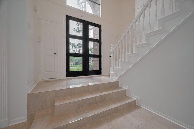 9411 Fenchurch Dr, Spring, TX 77379 - foyer featuring stairway, healthy amount of natural light, and a high ceiling