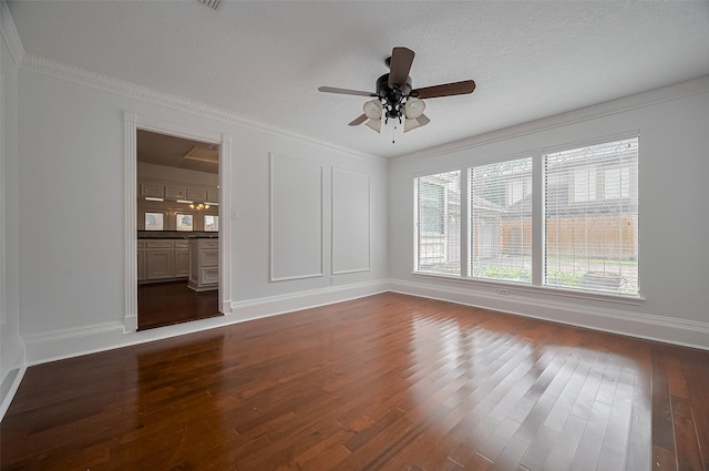 9411 Fenchurch Dr, Spring, TX 77379 - spare room featuring dark wood-type flooring, a ceiling fan, and crown molding