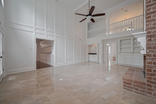 9411 Fenchurch Dr, Spring, TX 77379 - unfurnished living room featuring a decorative wall, marble tiled floors, a ceiling fan, and a high ceiling