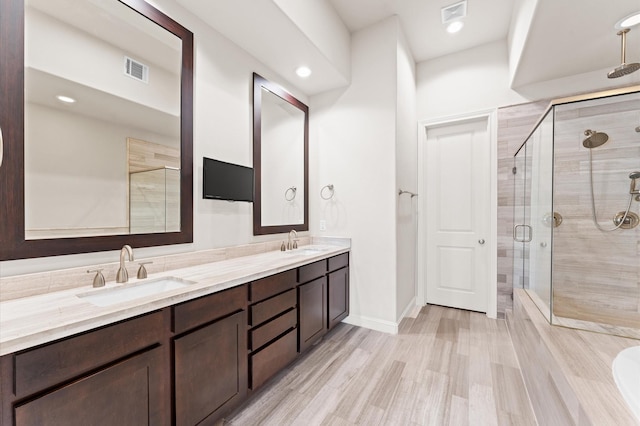 1705 Upland Lks, Houston, TX 77043 - full bathroom featuring double vanity, a stall shower, and wood finished floors