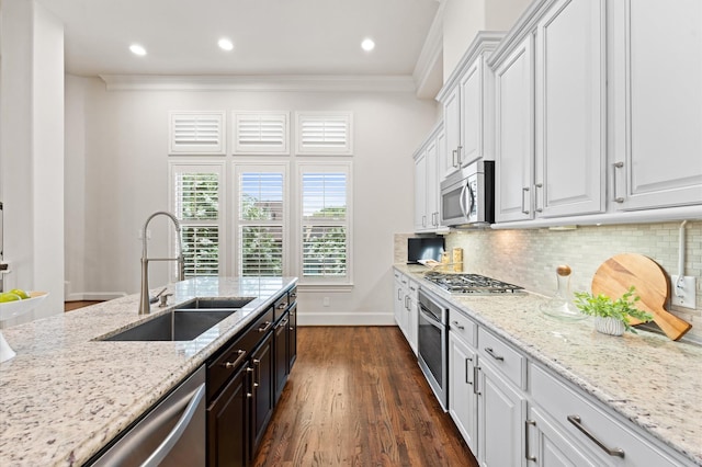1705 Upland Lks, Houston, TX 77043 - kitchen with appliances with stainless steel finishes, white cabinetry, crown molding, light stone counters, and tasteful backsplash
