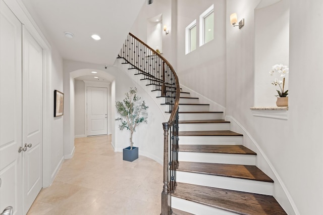 1705 Upland Lks, Houston, TX 77043 - staircase featuring arched walkways, recessed lighting, and tile patterned floors