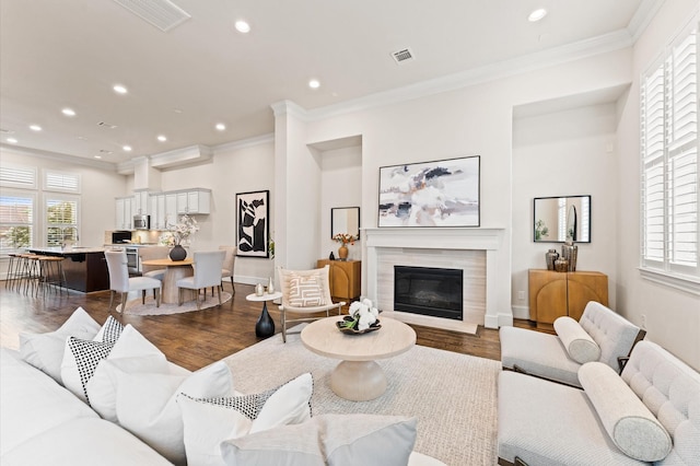 1705 Upland Lks, Houston, TX 77043 - living area featuring ornamental molding, dark wood finished floors, recessed lighting, and a glass covered fireplace
