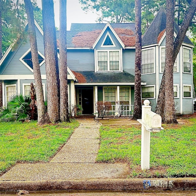 12006 Mill Trail Ln, Houston, TX 77070 - view of front of house featuring a porch, roof with shingles, and a front lawn