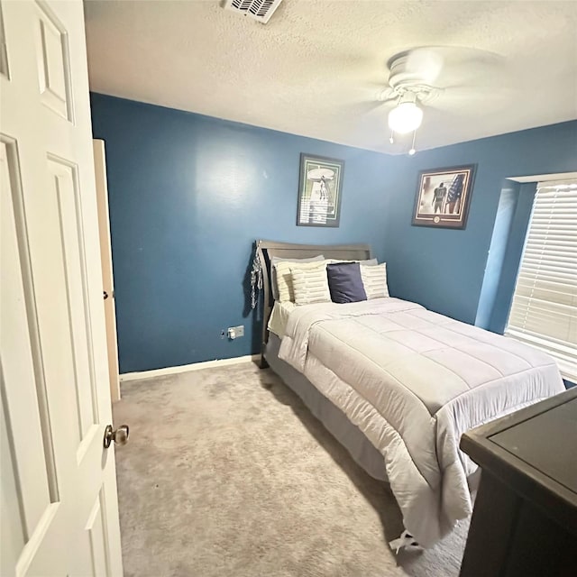 12006 Mill Trail Ln, Houston, TX 77070 - carpeted bedroom featuring a textured ceiling and a ceiling fan