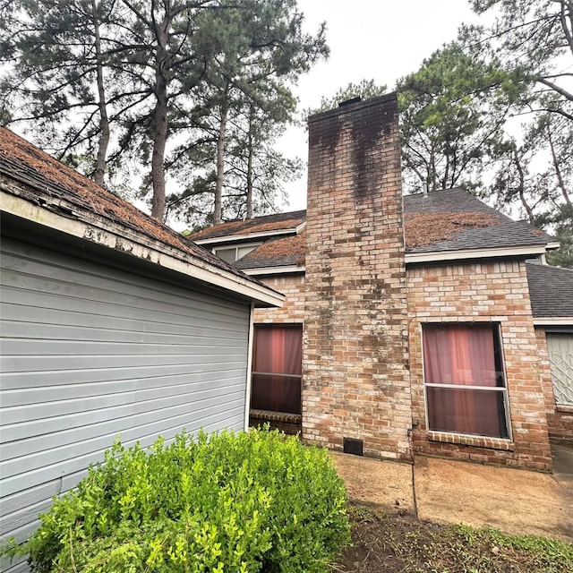 12006 Mill Trail Ln, Houston, TX 77070 - view of side of home featuring a chimney and a shingled roof