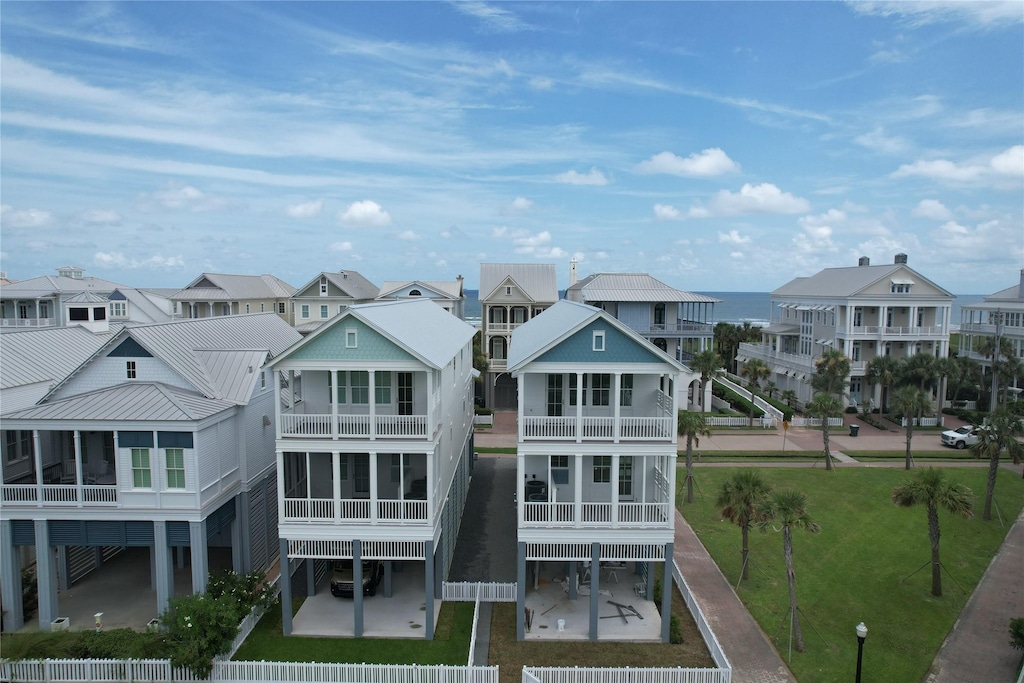 2602 E Seaside Dr, Galveston, TX 77550 - back of house featuring a residential view, a balcony, and a metal roof