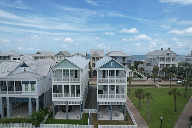 2602 E Seaside Dr, Galveston, TX 77550 - back of house featuring a residential view, a balcony, and a metal roof