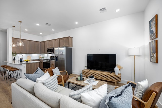 1546 W Tidwell Rd, Houston, TX 77091 - living area featuring wood finished floors and recessed lighting