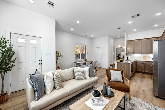 1546 W Tidwell Rd, Houston, TX 77091 - living area with light wood-style flooring and recessed lighting