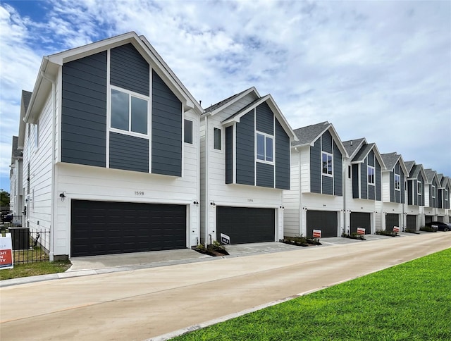 1546 W Tidwell Rd, Houston, TX 77091 - townhome / multi-family property with an attached garage and a residential view