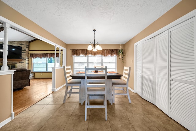 13202 N Decker Dr, Magnolia, TX 77355 - dining space featuring a textured ceiling, a chandelier, and tile patterned floors