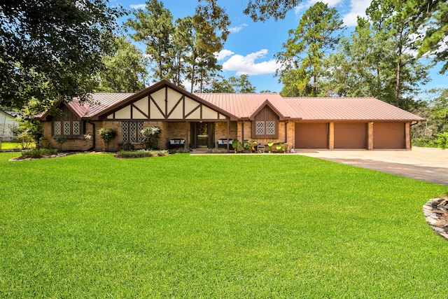 13202 N Decker Dr, Magnolia, TX 77355 - view of front of home featuring concrete driveway, a front yard, an attached garage, brick siding, and a metal roof