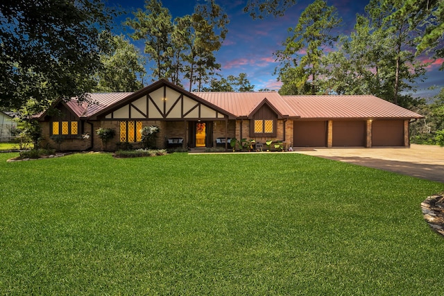 13202 N Decker Dr, Magnolia, TX 77355 - view of front facade featuring concrete driveway, a metal roof, a garage, a lawn, and brick siding