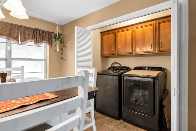 13202 N Decker Dr, Magnolia, TX 77355 - washroom featuring cabinet space, light tile patterned floors, and washing machine and clothes dryer