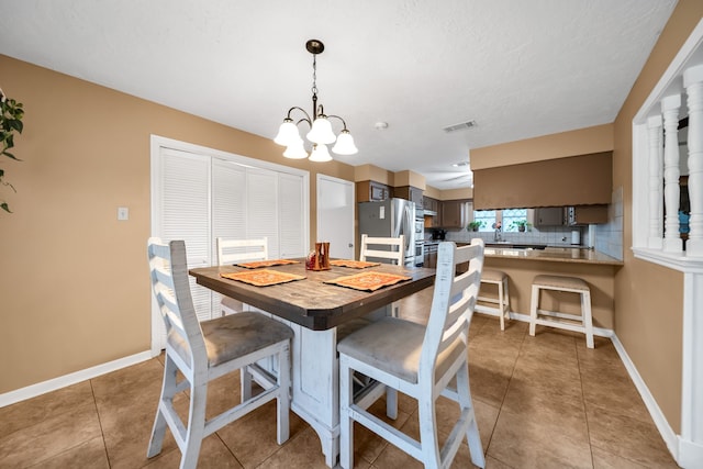 13202 N Decker Dr, Magnolia, TX 77355 - dining space with a chandelier and light tile patterned floors