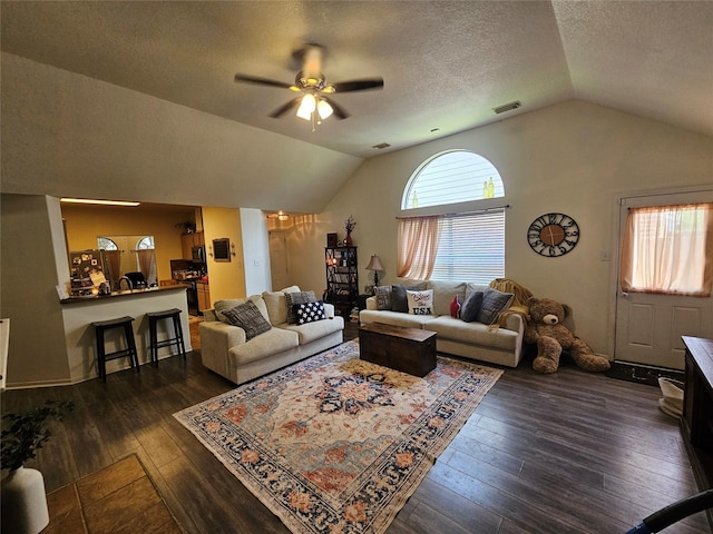 15506 Fir Woods Ln, Cypress, TX 77429 - living area with vaulted ceiling, dark wood-type flooring, ceiling fan, and a textured ceiling