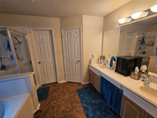 15506 Fir Woods Ln, Cypress, TX 77429 - bathroom with a shower stall, double vanity, tile patterned floors, a bath, and a textured ceiling