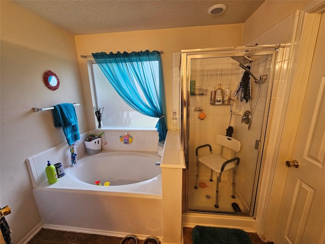 15506 Fir Woods Ln, Cypress, TX 77429 - bathroom featuring a garden tub, a shower stall, and a textured ceiling
